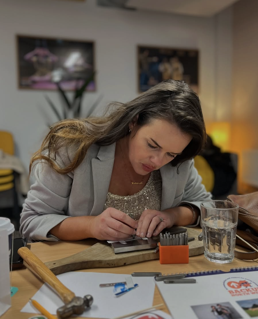 A participant focused on crafting a piece of handmade jewellery